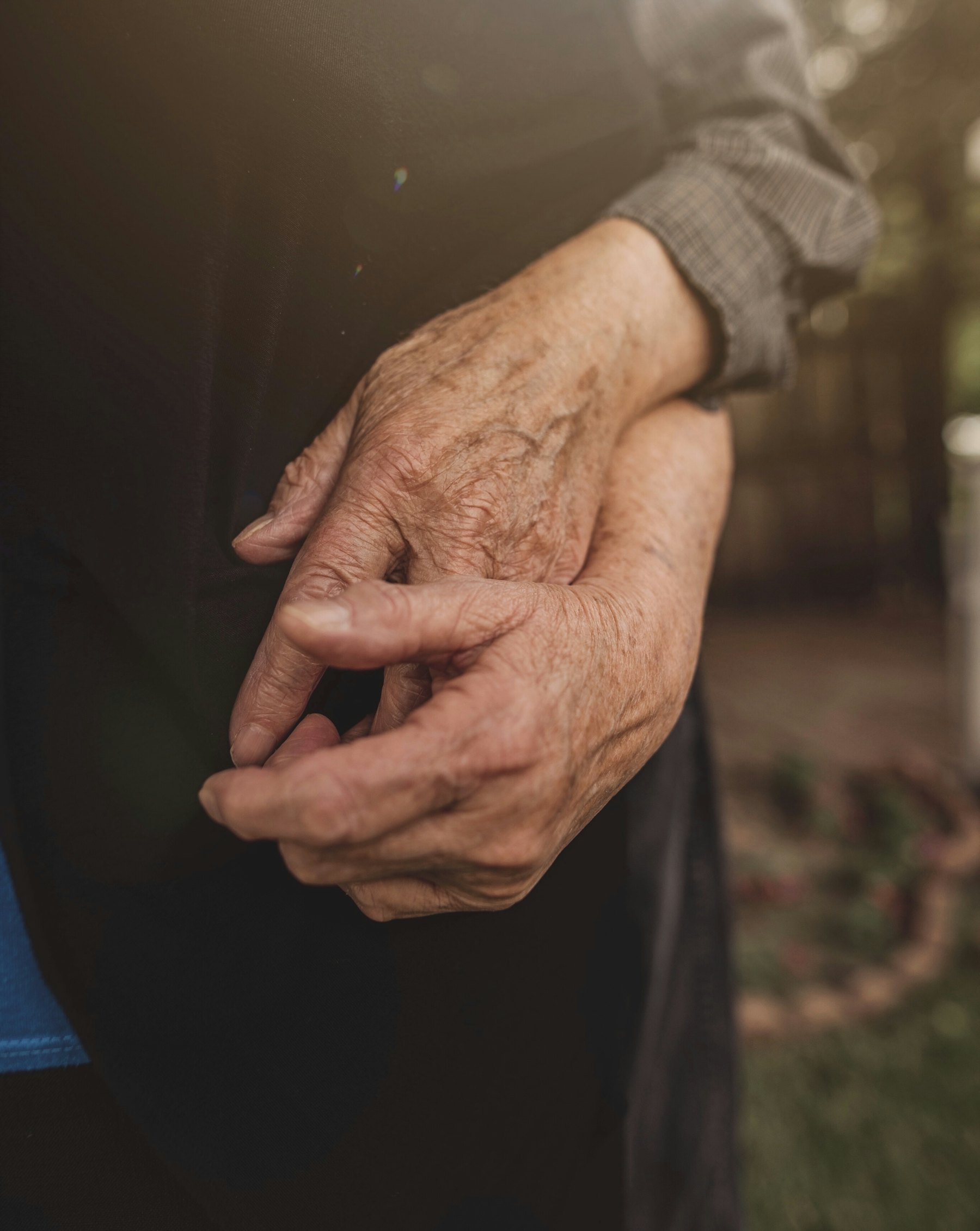 Clasped hands in warm backlight